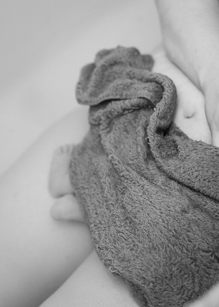 Greensboro Birth Photographer - Laboring mother in tub during home birth