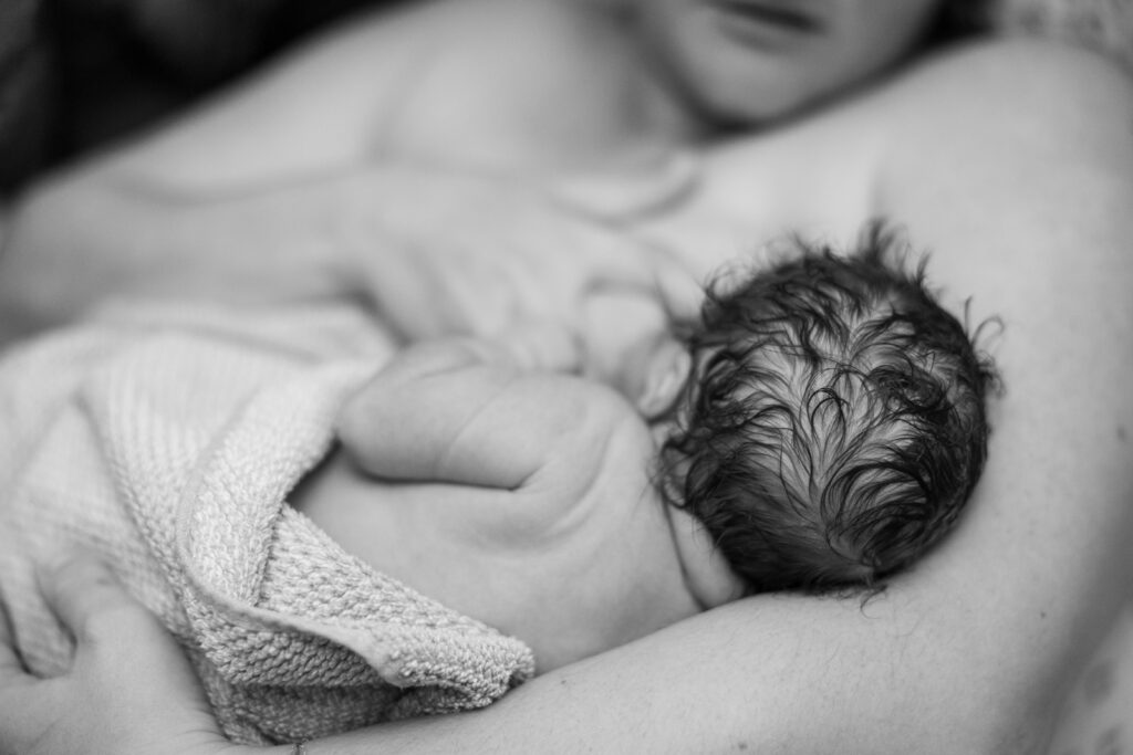 Greensboro Birth Photographer - baby on mother's chest after home birth